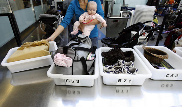 Airport security: Los Angeles, US: A passenger holds her baby at a security checkpoint