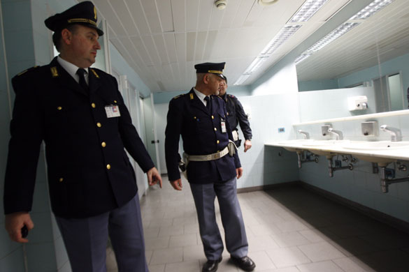 Airport security: Milan, Italy: Policemen look at where a suspicious package was found