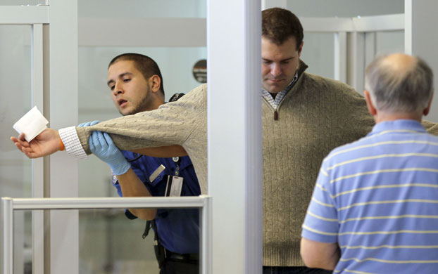 Airport security: New Jersey, US: A TSA officer carries out a physical search