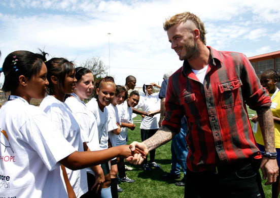 Beckham in South Africa: David Beckham greets a group of children at the 'Coaching For Hope' project