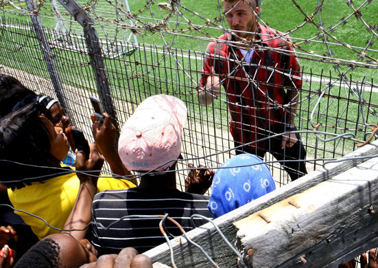 Beckham in South Africa: David Beckham chats with Khayelitsha township resident