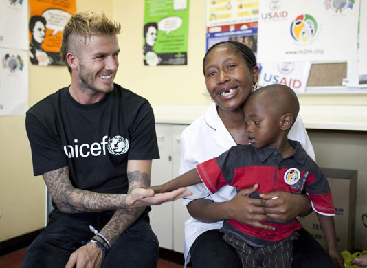 Beckham in South Africa: UNICEF Ambassador Beckham meets Sesiphi and Tamara at a clinic in Cape Town