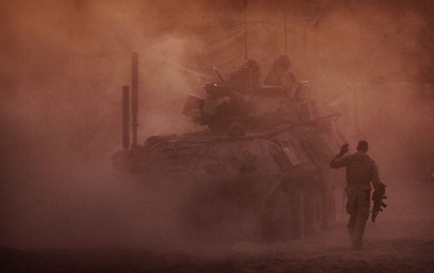 4 December 2009: Helmand Province, Afghanistan: A US Marine walks toward a LAV vehicle