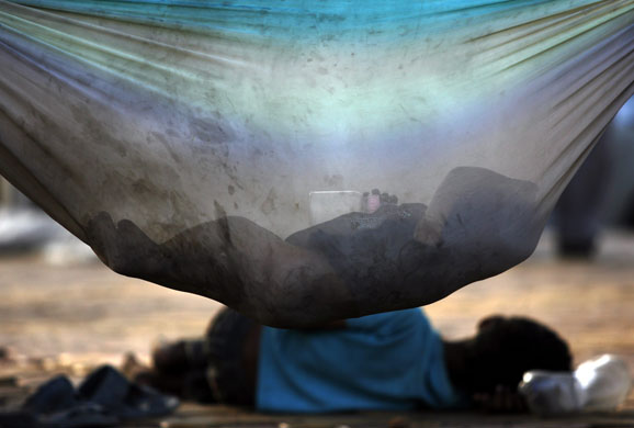 4 December 2009: Mumbai, India: A child sleeps in a makeshift cradle