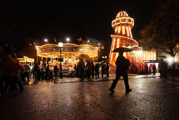 Winter Wonderland: People walk past old fashioned fairground rides at Winter Wonderland