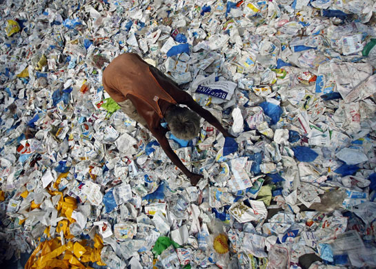 24 Hours: A worker spreads out plastic bags for recycling at Dombivili