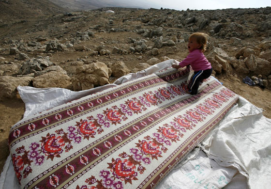 24 hours: Yatta, West Bank: A Palestinian toddler cries as she stands on a mattress