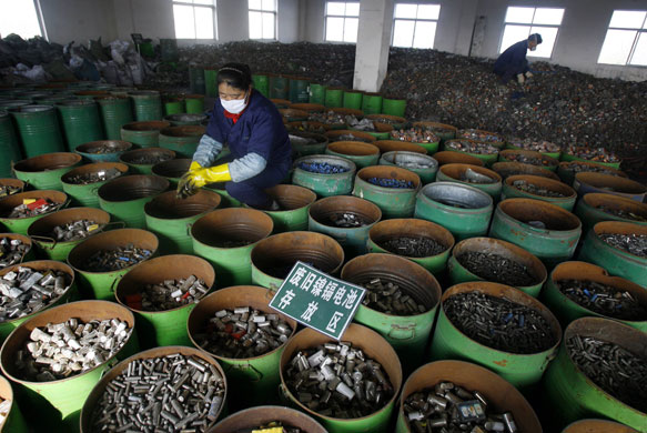 24 hours: Wuhan, China: Workers sort batteries at electronic waste recycling factory