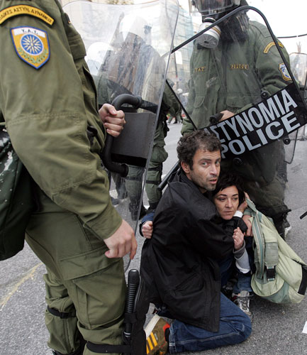 Athens demonstrations: Protesters are detained by policemen during a march
