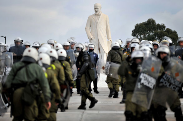 Violence in Athens: Greek riot police stand around of a statue Eleftherios Venizelos 
