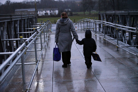 Workington: A mother and child cross the bridge