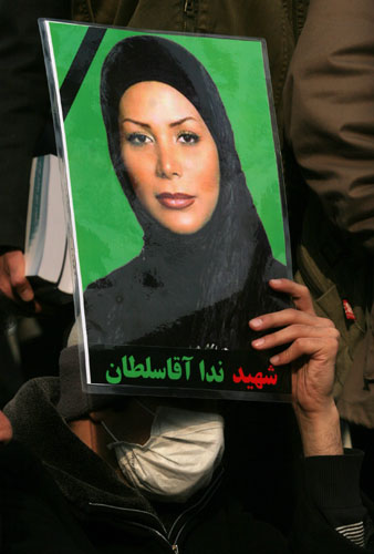 Tehran protests: An Iranian opposition supporter holds a picture of Neda Agha Soltan