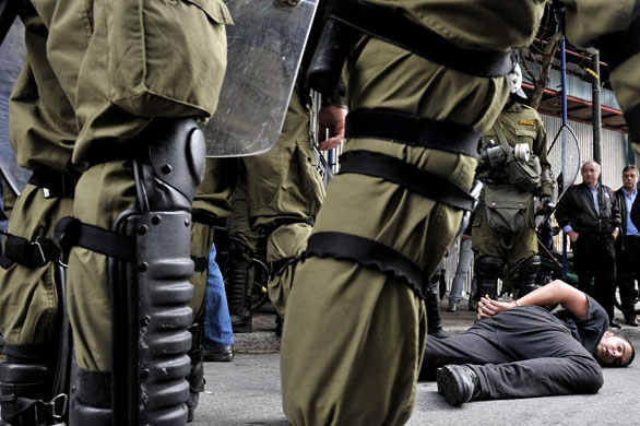more voilence in athens : Police stand around a detained youth during clashes in central Athens 