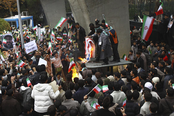 More violence in Tehran: Pro-government Iranian students burn a representation of the US flag