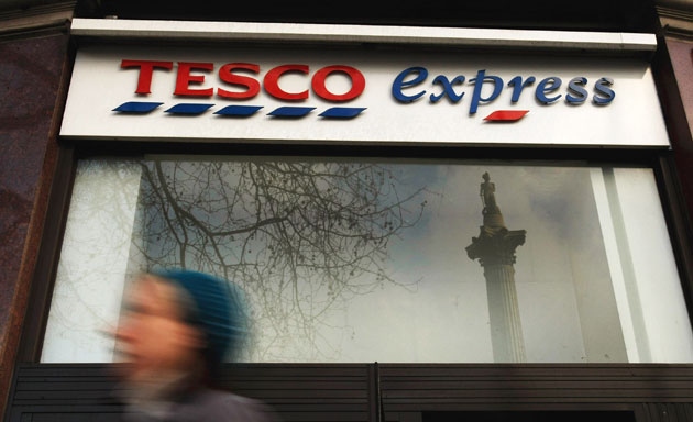 Year in Business: People walk past a Tesco express store in central London