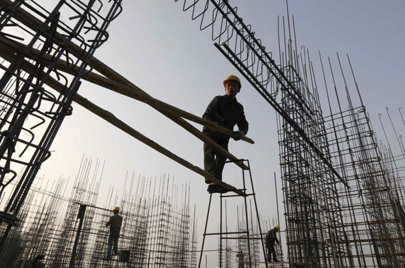 Year in Business: Labourers work on scaffoldings at a construction site in Changzhi
