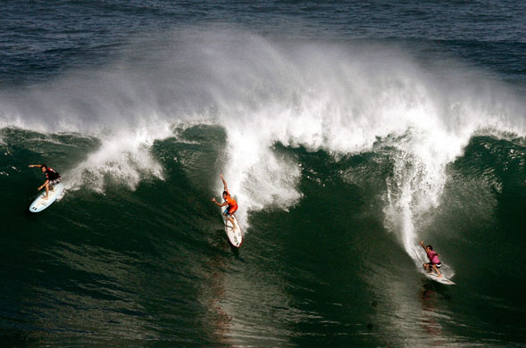 Hawaii waves: Makuakai Rothman, Sunny Garcia, and Ibon Amatrian ride a wave