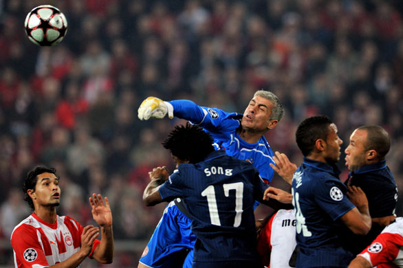 Wednesday Champ League: Olympiacos goalie Antonis Nikopolidis punches the ball clear 