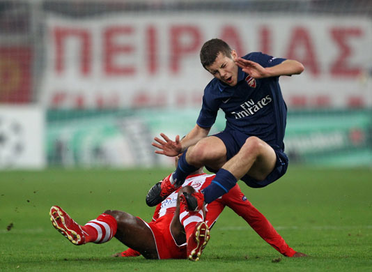 Wednesday Champ League: Arsenal's Jack Wilshire is scythed down by Leonardo of Olympiakos 
