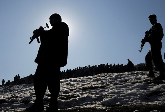 Gallery 24 hours in pictures: Policemen stand guard at the site of a suicide bomb attack in Kabul. 