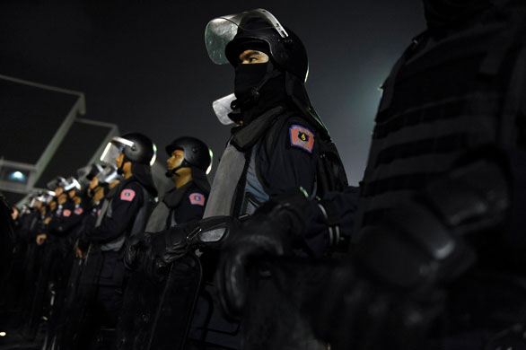 Gallery 24 hours in pictures: Thai riot police get in position to stop thousand of protesters.