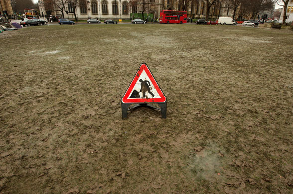 Continuing bad weather: The grass in Parliament Square in London which has been turned to mud