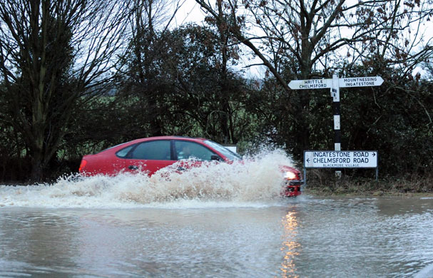 Continuing bad weather: A car drives through floodwater in Blackmore village, Essex