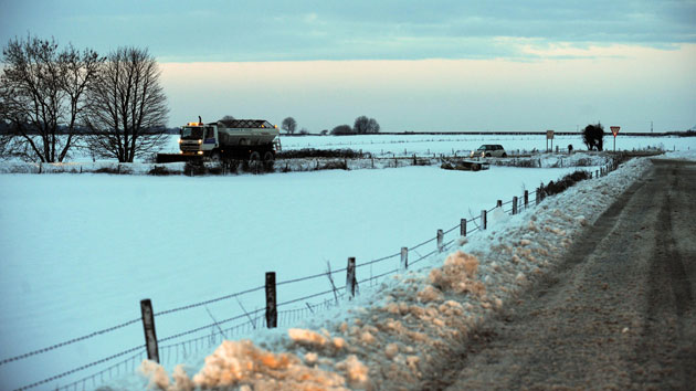 Continuing bad weather: A snow plough and gritting lorry on the Gloucester to Tetbury road