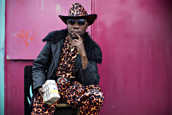 24 hours in pictures : A money changer poses for a portrait in Goma in eastern Congo