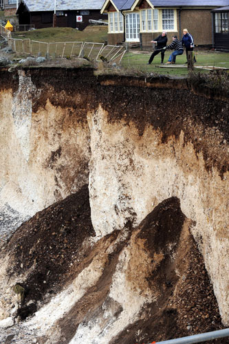 Bad weather: Workers pull back the defensive barrier at Birling Gap