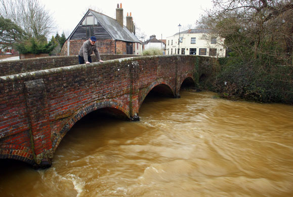 Bad weather: A resident of Wallington near Fareham, Hampshire, looks at the river