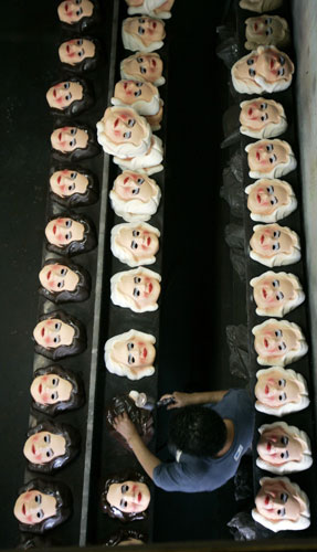 11 February 2009: Rio de Janeiro, Brazil: A worker puts finishing touches to masks