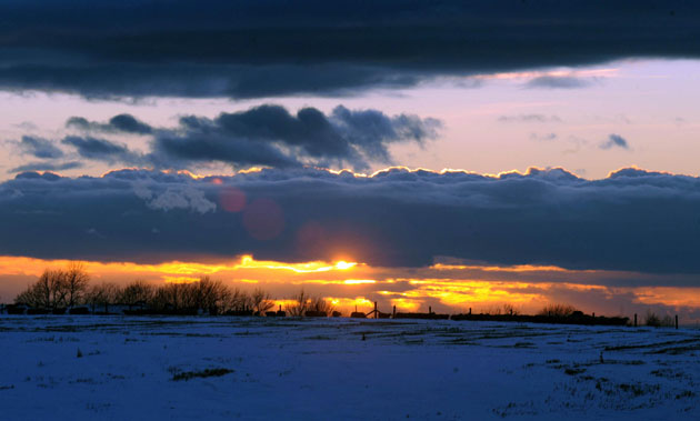 11 February 2009: Wotton-under-Edge, UK: The sun sets over snow covered fields