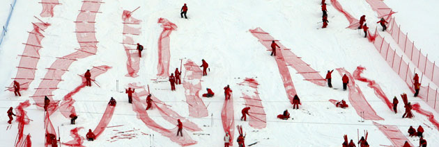 11 February 2009: Val d'Isere, France: Volunteers prepare the race course