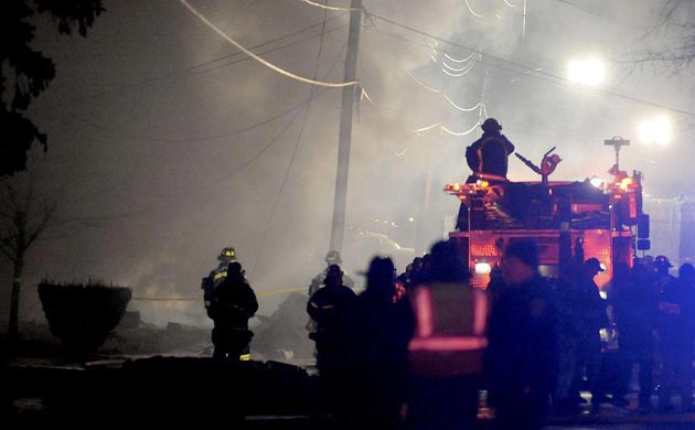 Firefighters survey the wreckage of Buffalo plane crash
