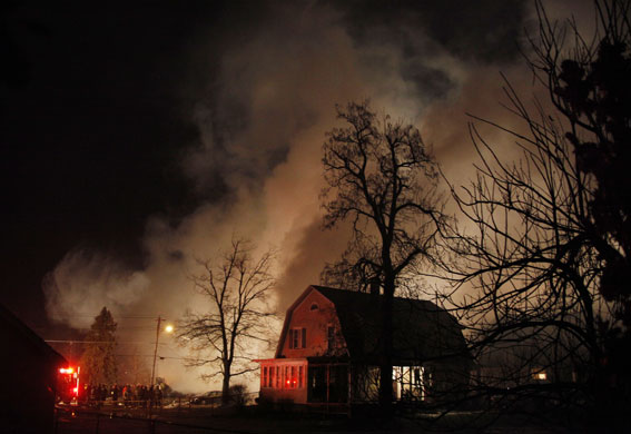 New York plane crash: Smoke rises from the burning plane and home in Buffalo.