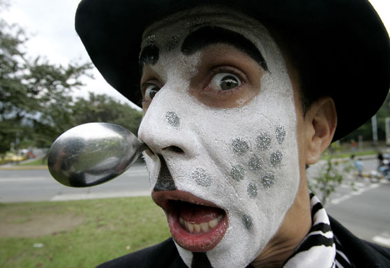 24 hours in pictures: A local artist performs at a main street in downtown Medellin