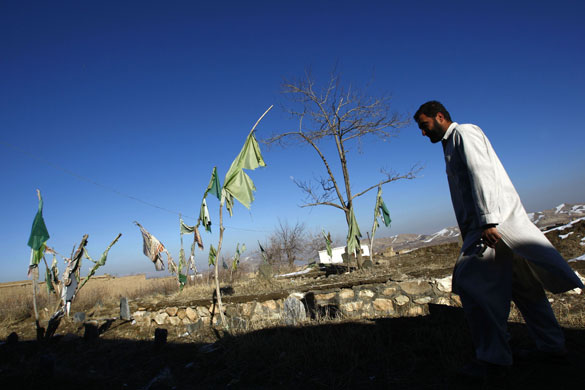 24 hours in pictures: Afghanistan: Abdul Wassay walks past an old cemetery. 