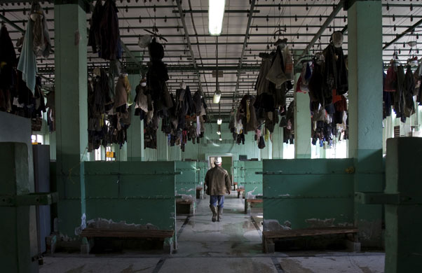 24 hours in pictures: Mitrovica, Kosovo: A miner walks out of the dressing room at Trepca Mines.