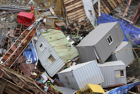 24 hours in pictures: Seongnam, south Korea: Rescue workers search a collapsed building.