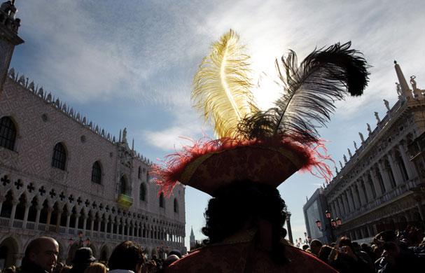 Venice carnival: A costumed reveller walks near St Mark's square.