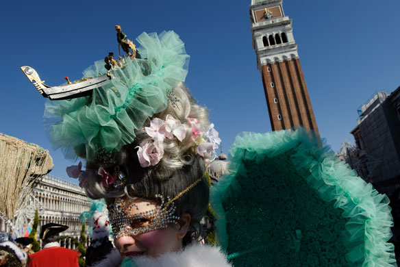Venice carnival: A woman dressed as Marie Antoinette poses in St Mark's square