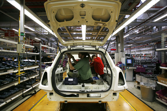 Cowley mini production: Workers on BMW's Mini production line at their factory in Cowley, Oxford.