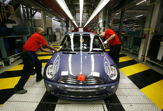 Cowley mini production: Workers on BMW's Mini production line at their factory in Cowley, Oxford.
