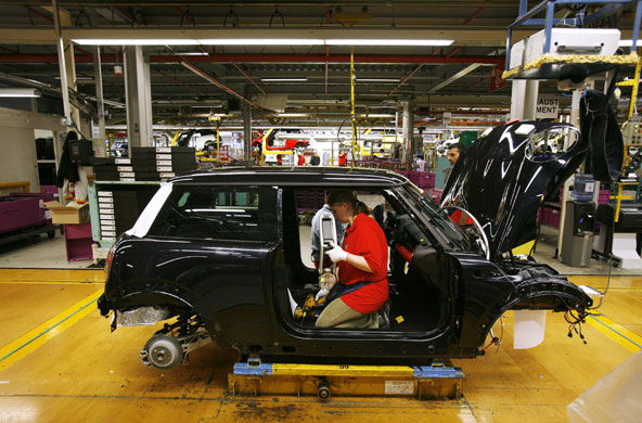 Cowley mini production: Workers on BMW's Mini production line at their factory in Cowley, Oxford.