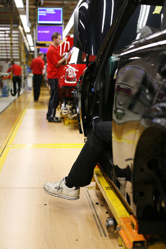 Cowley mini production: Workers on BMW's Mini production line at their factory in Cowley, Oxford.