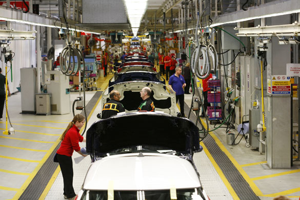 Cowley mini production: Workers on BMW's Mini production line at their factory in Cowley, Oxford.