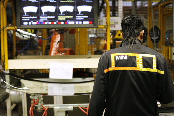 Cowley mini production: A worker on BMW's Mini production line at their factory in Cowley, Oxford.
