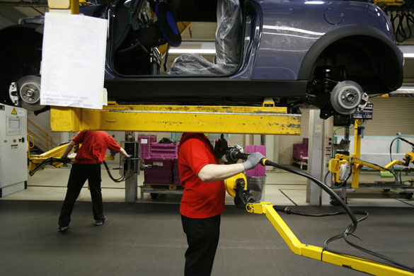 Cowley mini production: Workers on BMW's Mini production line at their factory in Cowley, Oxford.