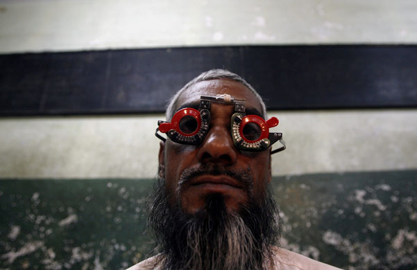 24 hours in pictures: A man gets his eye tested at a free eye-care camp in Mumbai